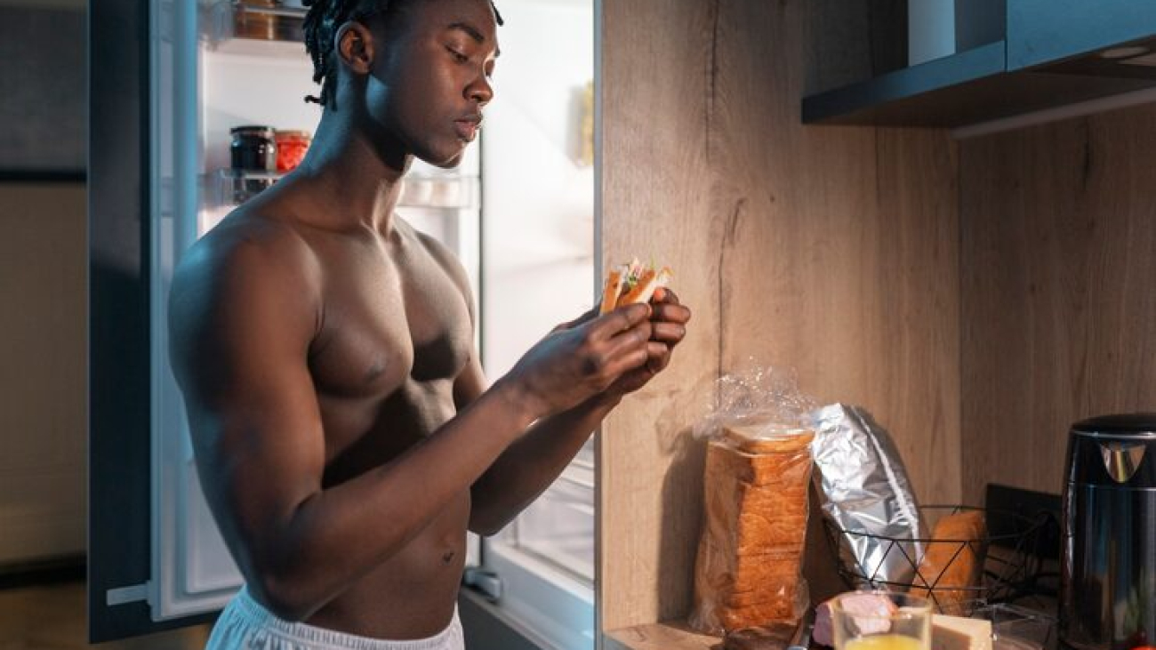 young-man-having-snack-middle-night-home-fridge_23-2150251940
